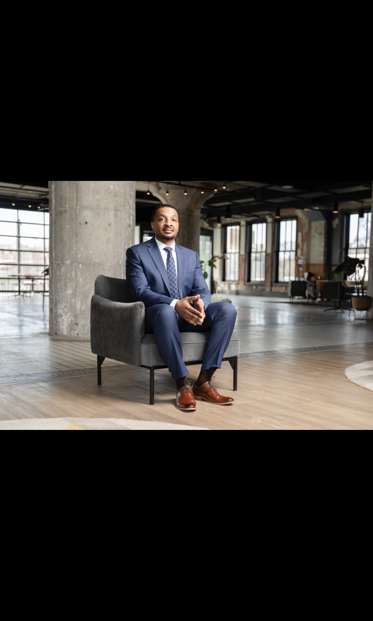 Christopher Edwards, founder of Common Sense, seated in an industrial loft